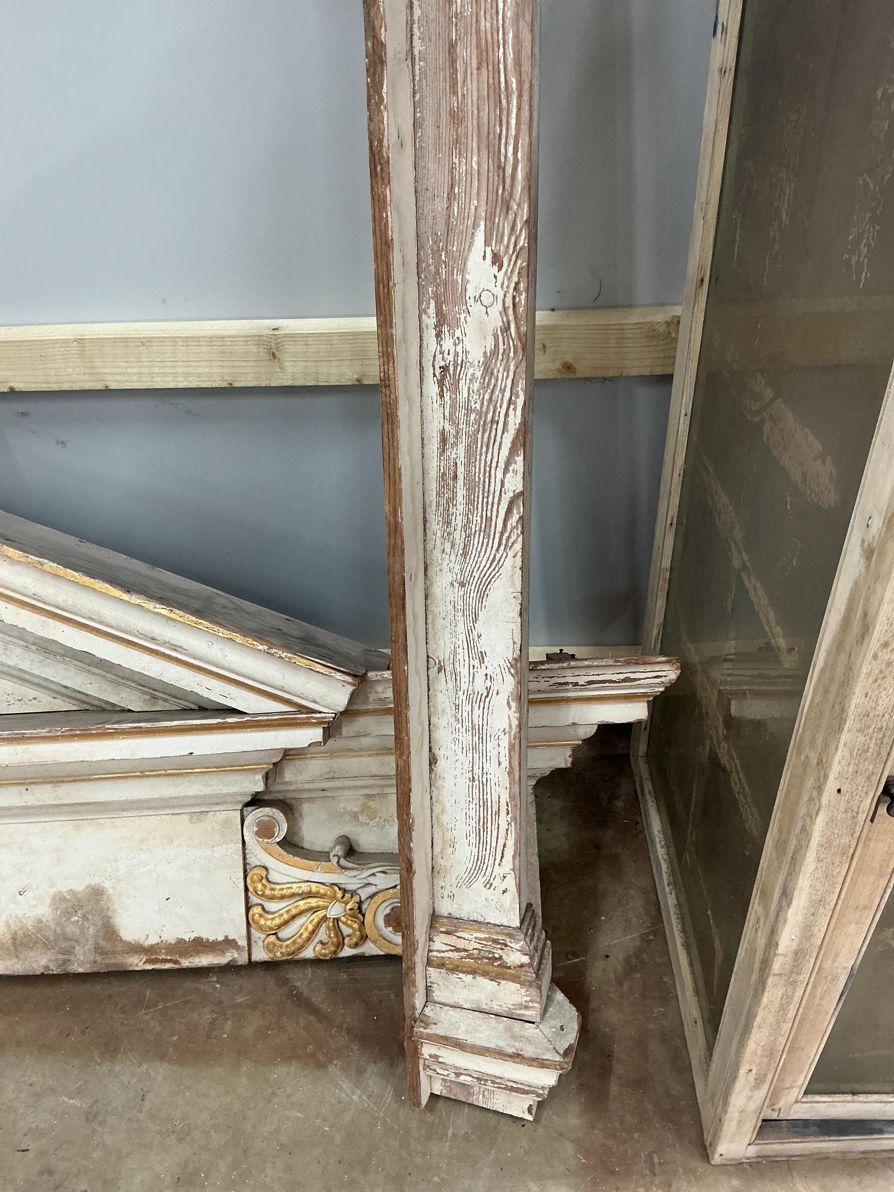 A large late 18th century painted parcel gilt pine door surround, width 154cm, height approximately 266cm